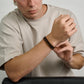 Black stainless steel Franco link bracelet paired with brown leather and Tiger Eye beaded bracelets  