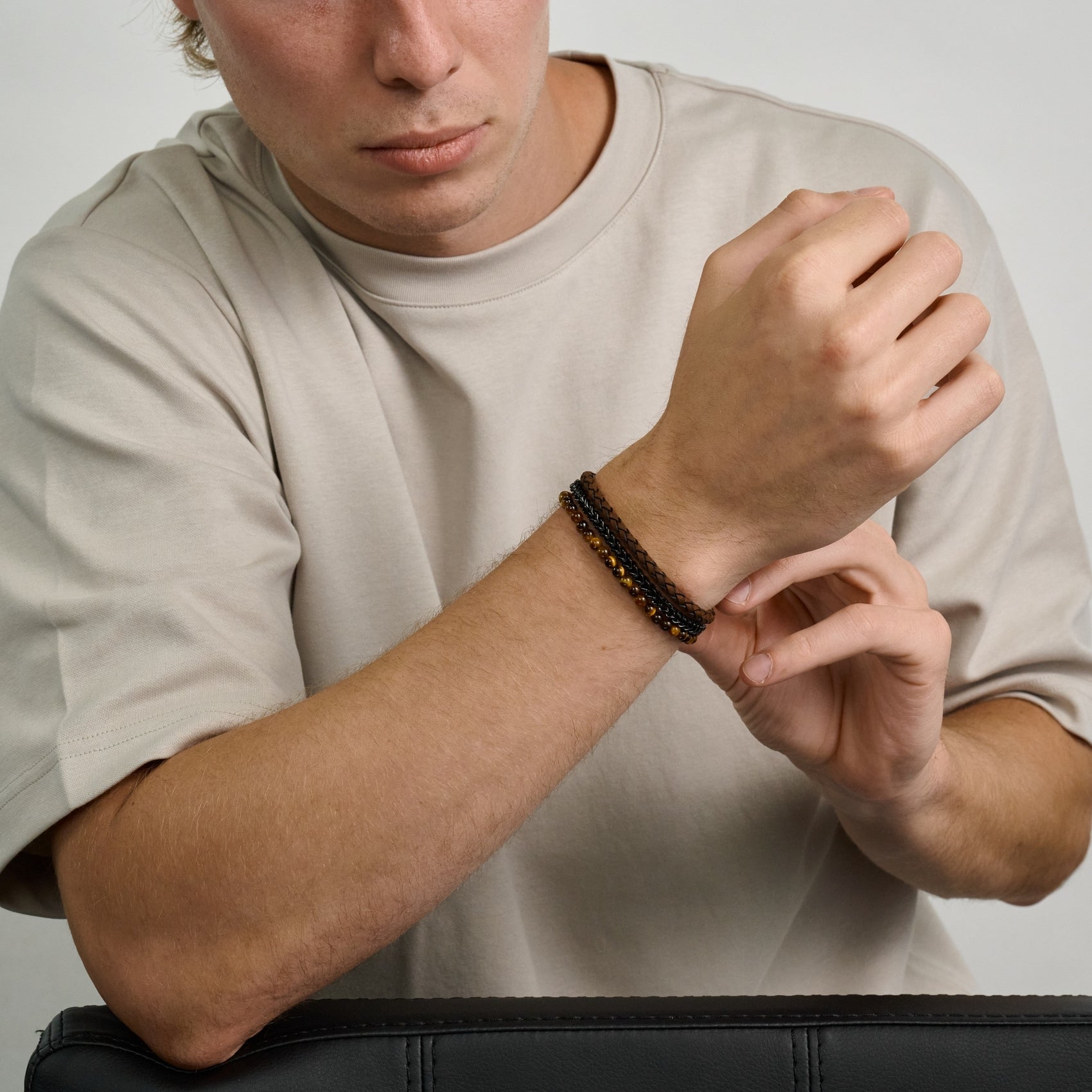 Black stainless steel Franco link bracelet paired with brown leather and Tiger Eye beaded bracelets  