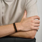 Close-up of high-quality stainless steel and leather bracelets with natural stone beads for men  