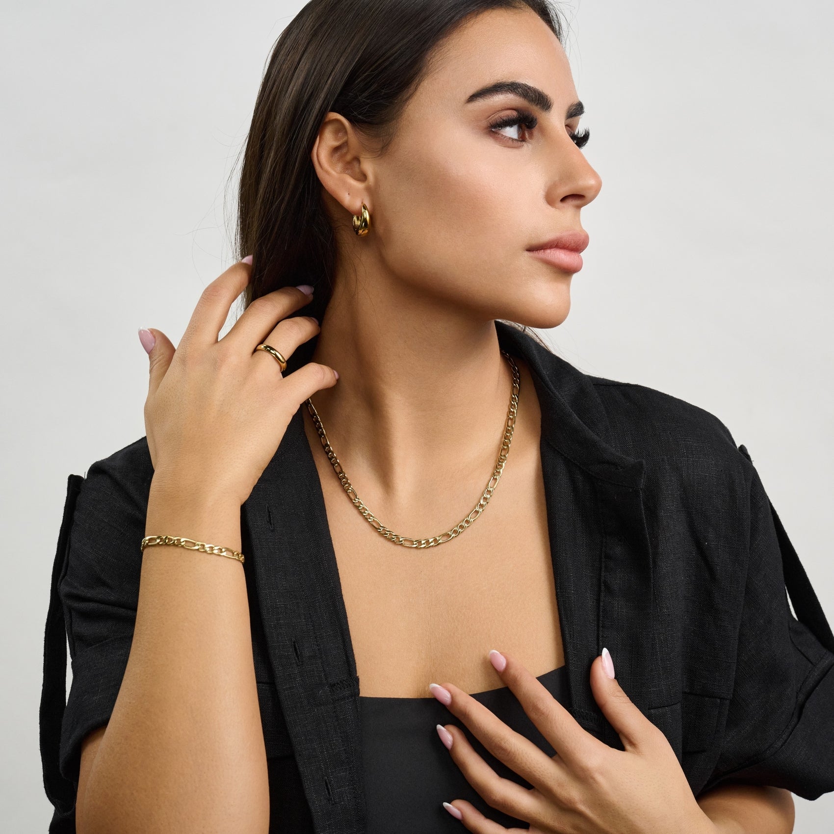 Silver-tone Figaro link chain necklace featuring distinctive pattern and sturdy construction  