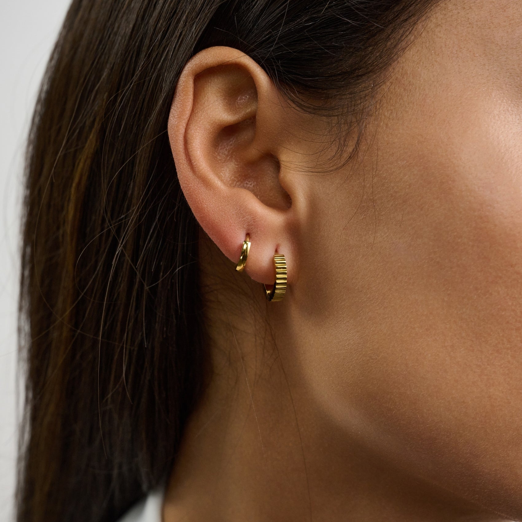 Pair of high-quality stainless steel huggie earrings featuring a stylish rippled texture  