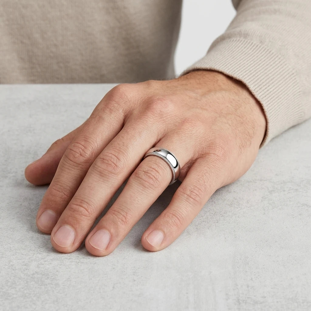 Enhanced Close-up of a polished 6mm stainless steel wedding band with milgrain edges and a domed profile  