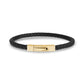 Female and male hands wearing sleek square leather bracelet with metallic clasp  