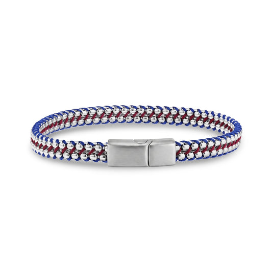 Men's steel bracelet with intertwined red and blue tethered cords over box chain links, laid flat showing the engravable matte clasp centered at the front.