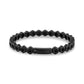 Front view of the matte black hexagon link tennis bracelet showing the engravable click-in clasp at center