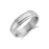 Close-up of a 6mm stainless steel wedding ring with milgrain detailing and polished finish.  