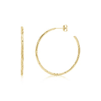 Faceted slim hoop earrings in shiny gold stainless steel with 42mm diameter, shown from front and side views