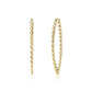 Gold large oval twist hoop earrings on white background