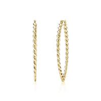 Gold large oval twist hoop earrings on white background