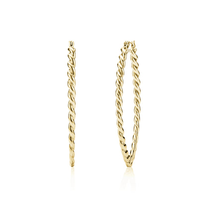 Gold large oval twist hoop earrings on white background