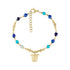 Gold stainless steel bracelet with blue beads and a turtle charm on a white background