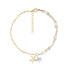 Two-tone gold and silver charm bracelet with starfish and turtle charms on white background