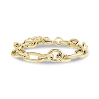 Chunky mixed link chain bracelet in polished gold stainless steel on white background