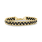 Woven bead link bracelet made of gold-tone stainless steel and black spinel beads with a lobster clasp