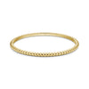 Gold tone women's bubble edge bangle bracelet featuring rounded bubble edge design on white background