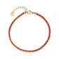 Gold-tone stainless steel woven cord bracelet with red thread and lobster clasp, showing adjustable chain and polished beads