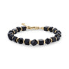 Geometric black onyx stone bead bracelet with gold stainless steel accents and lobster clasp on a white background