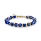 Geometric lapis lazuli stone bead bracelet with gold stainless steel accents and lobster clasp on a white background