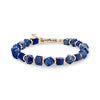 Geometric lapis lazuli stone bead bracelet with gold stainless steel accents and lobster clasp on a white background