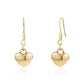 Gold dangling heart earrings made from polished stainless steel with smooth, reflective heart pendants