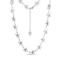 Silver stainless steel starfish link necklace with heart charm extension on white background