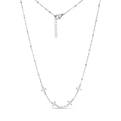 Silver stainless steel necklace with five small cross charms and beaded chain detailing, showing adjustable lobster clasp.