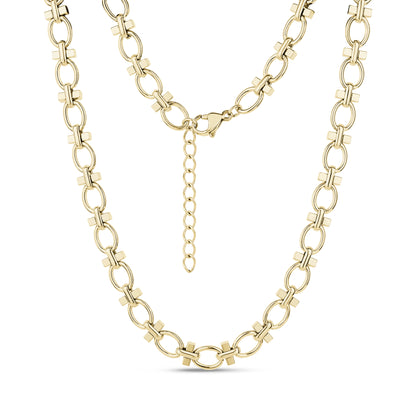 Close-up of structured link necklace in gleaming gold stainless steel with oval and cross-shaped links, showing lobster clasp and extension chain