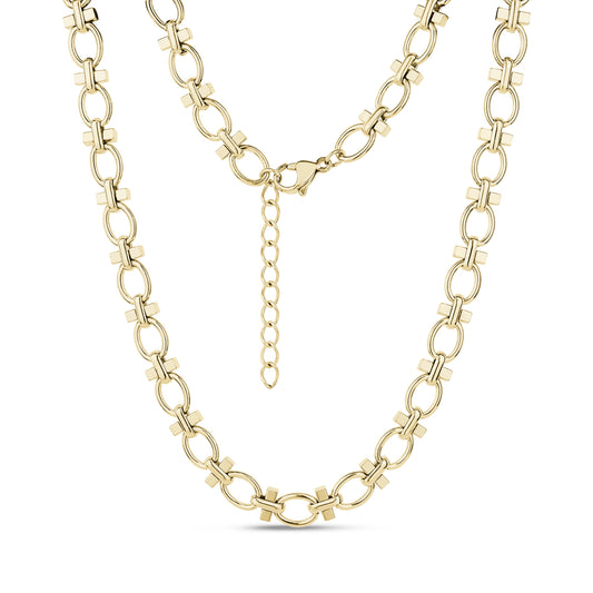 Close-up of structured link necklace in gleaming gold stainless steel with oval and cross-shaped links, showing lobster clasp and extension chain