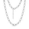 Close-up of structured link necklace in shiny silver stainless steel with oval and cross-shaped links, showing lobster clasp and extension chain