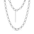 Close-up of structured link necklace in shiny silver stainless steel with oval and cross-shaped links, showing lobster clasp and extension chain