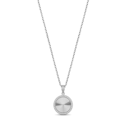 Close-up of silver cubic zirconia round pendant showing stone detail and engravable back plate