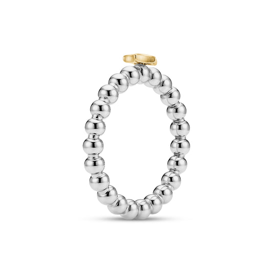 Top view of a round beaded stainless steel ring featuring a gold star accent