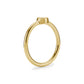 Side profile of gold tone bezel set solitaire ring showing smooth band and raised bezel