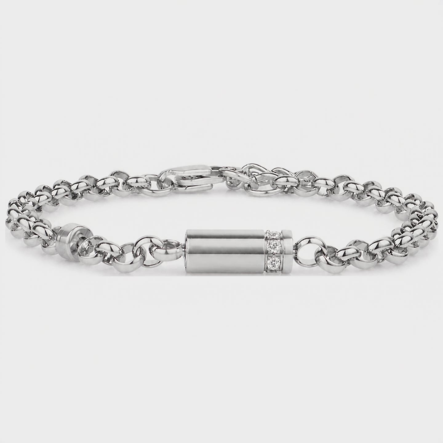 Video of a silver stainless steel lab diamond urn bracelet on a rolo link chain, showing the cylindrical memorial capsule with a row of lab diamonds and lobster clasp