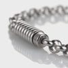 Close-up video of the silver ribbed capsule urn bracelet, showing the ribbed stainless steel ash holder charm and polished rolo link chain up close
